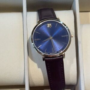 MOVADO blue face, yellow gold trim, dark leather band. No damage.